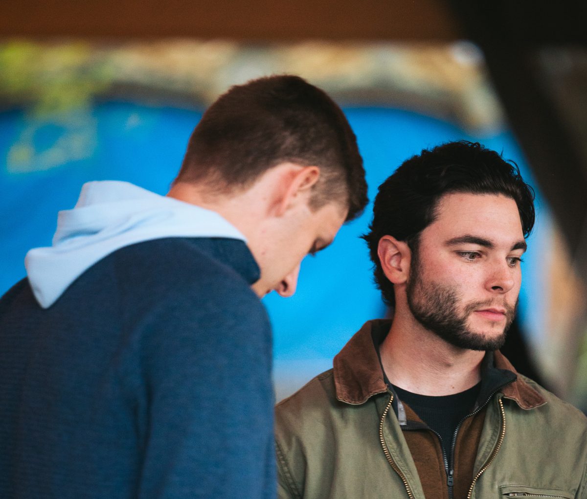 Two men, one holding a Bible
