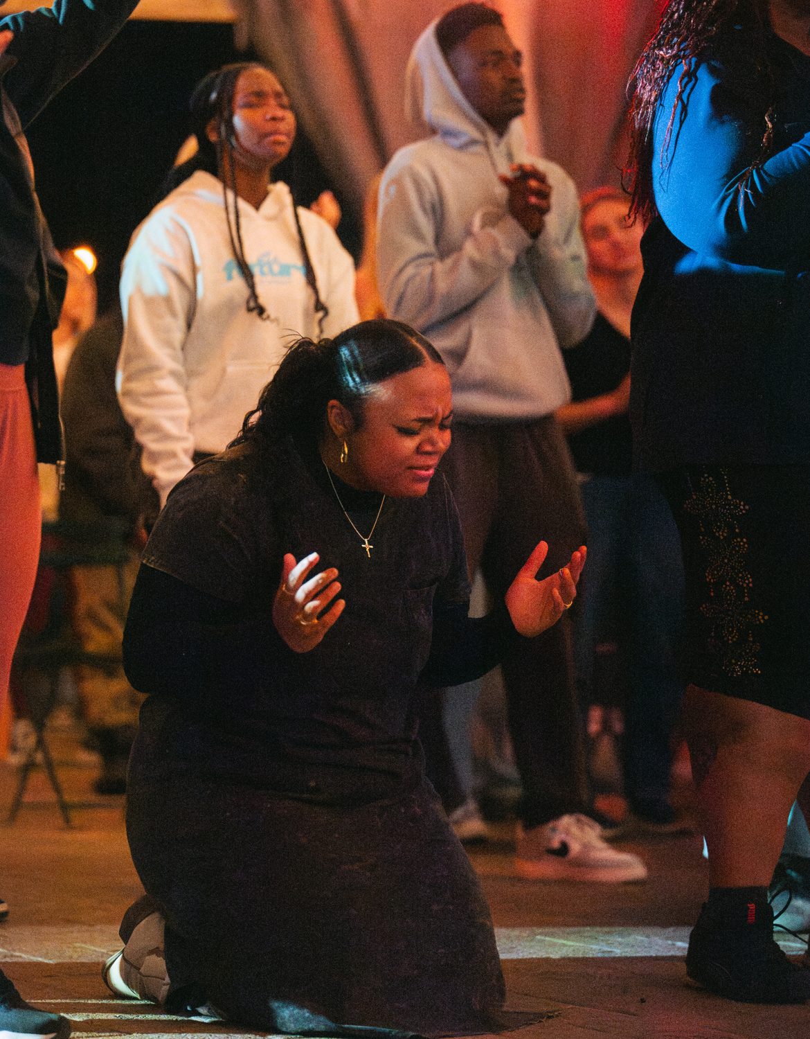 A worshipper on her knees, hands open